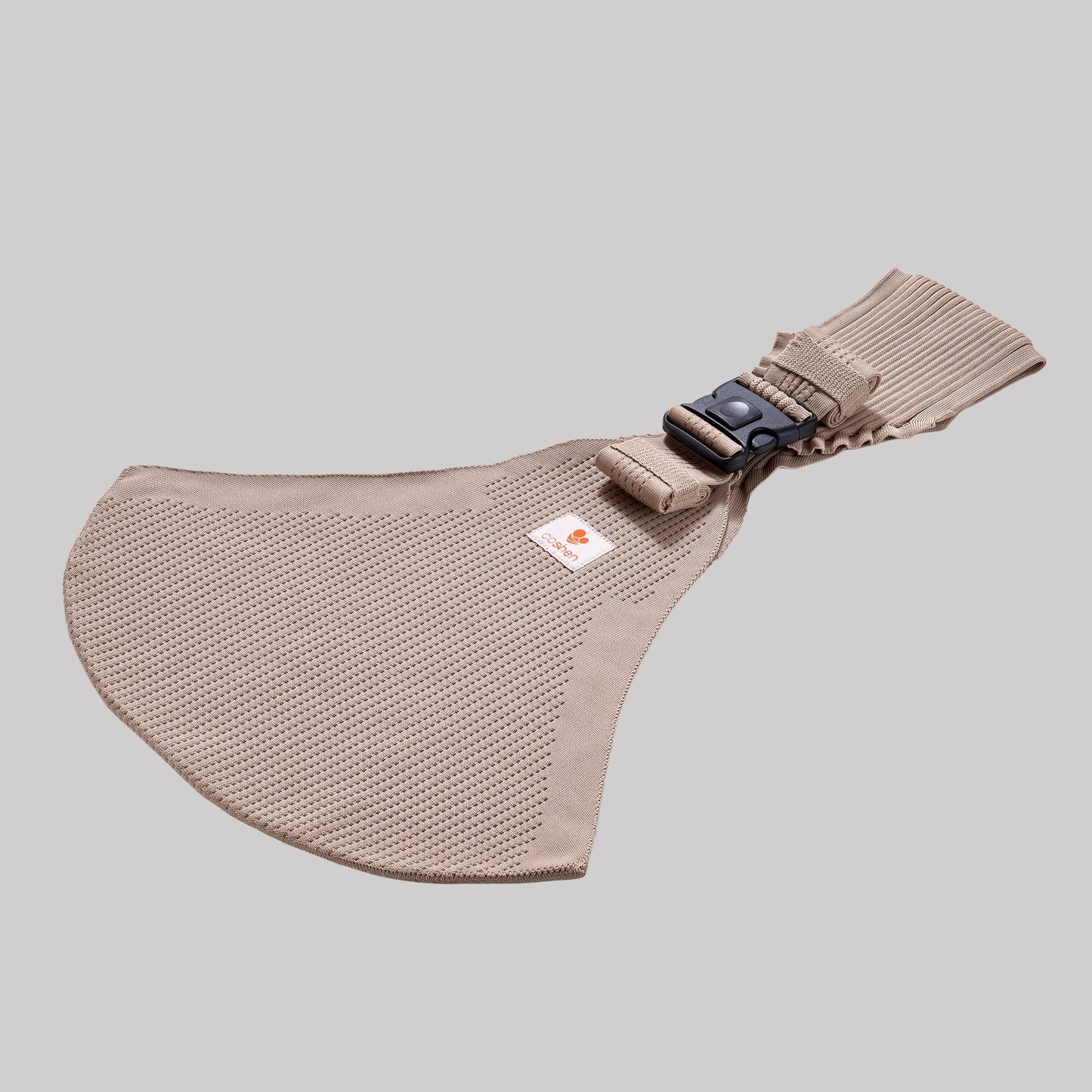 Perspective view of the Coshen baby carrier in sand beige, highlighting the 3D knit technical textile, side buckle detail, and breathable fabric structure.