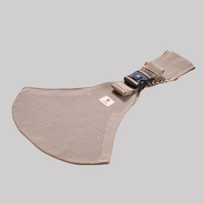 Perspective view of the Coshen baby carrier in sand beige, highlighting the 3D knit technical textile, side buckle detail, and breathable fabric structure.